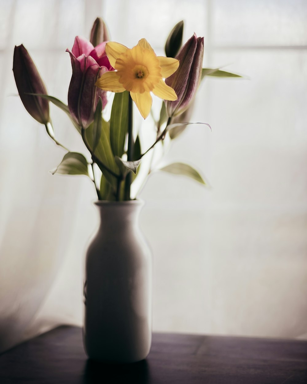 a vase filled with flowers on top of a table