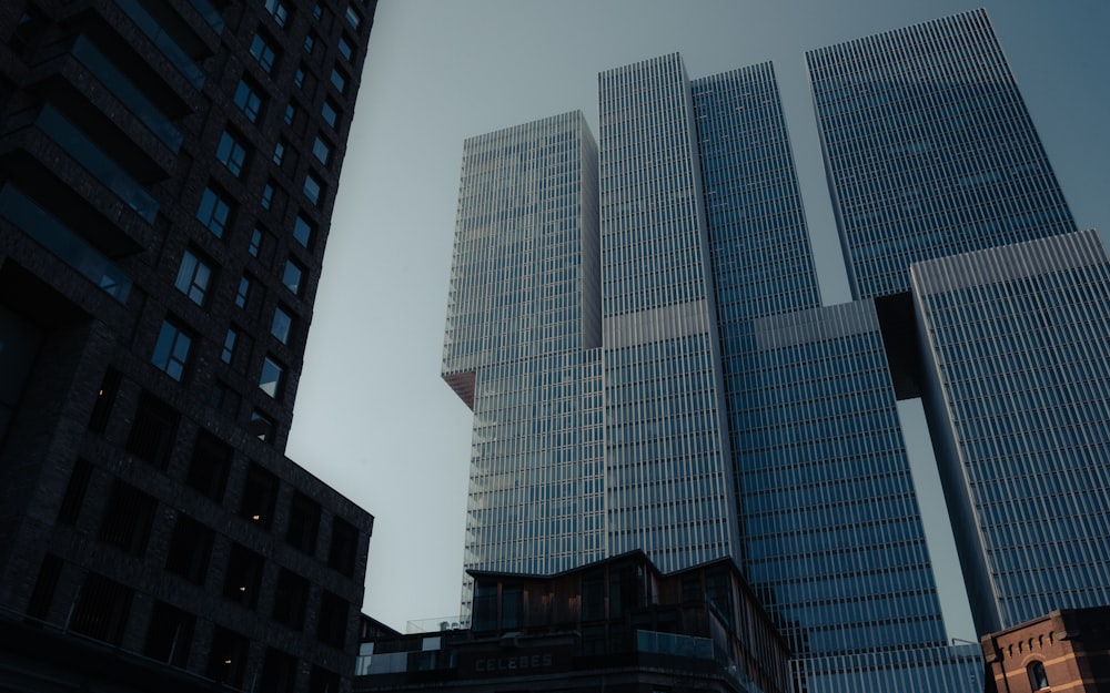 a couple of tall buildings sitting next to each other
