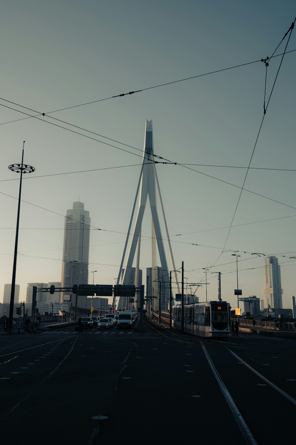 a train traveling over a bridge next to tall buildings