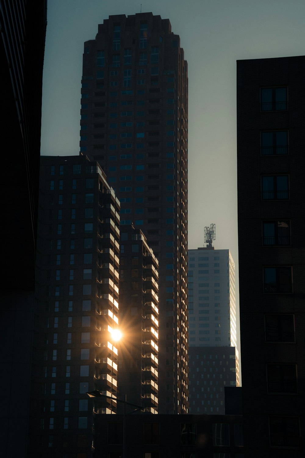 the sun shines brightly through the windows of tall buildings