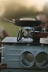 a grill that has some pots and pans on it