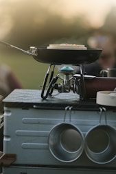 a grill that has some pots and pans on it