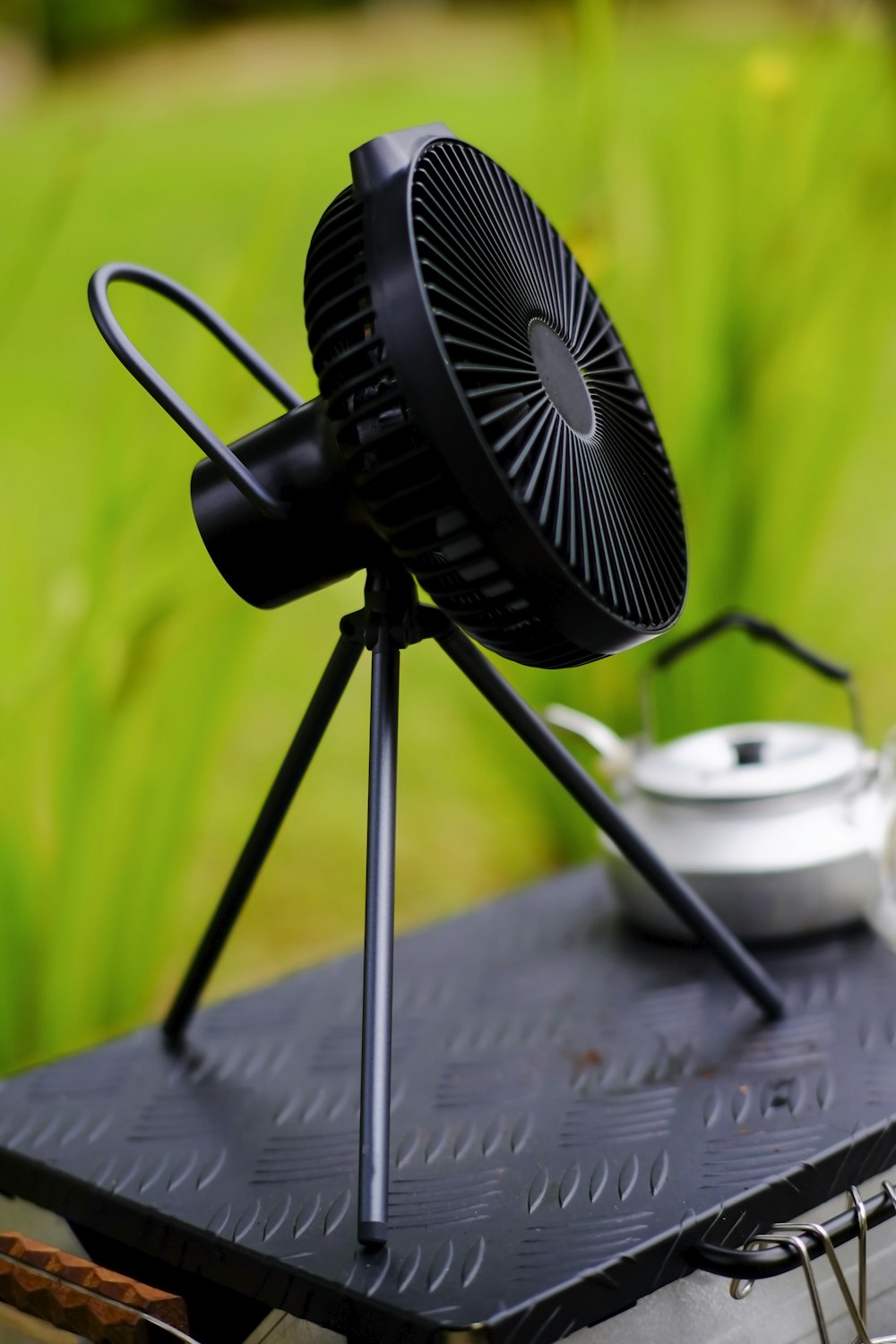 a black fan sitting on top of a table