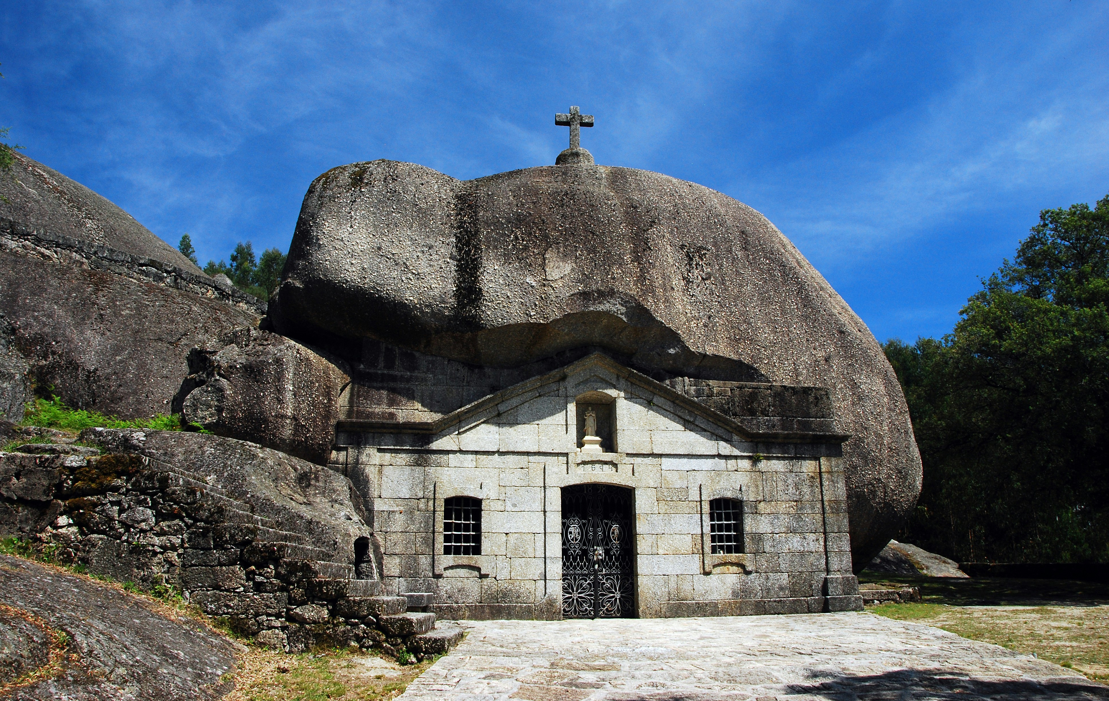 a stone church with a cross on top of it