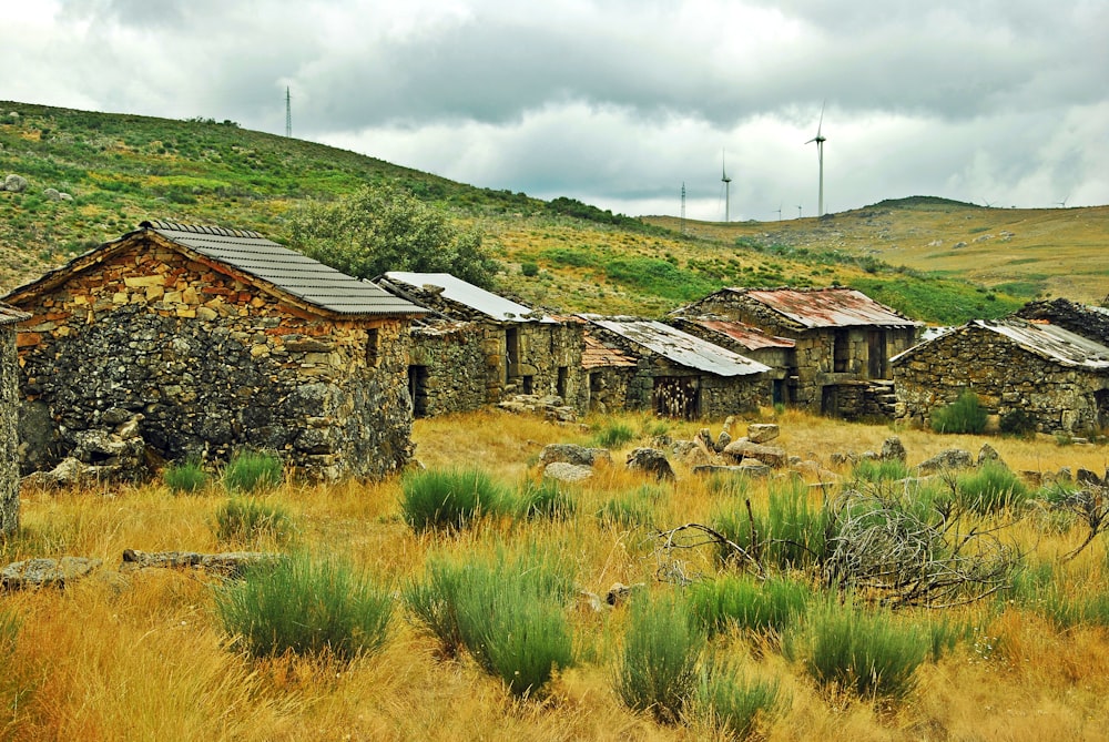 an old stone building in the middle of a field