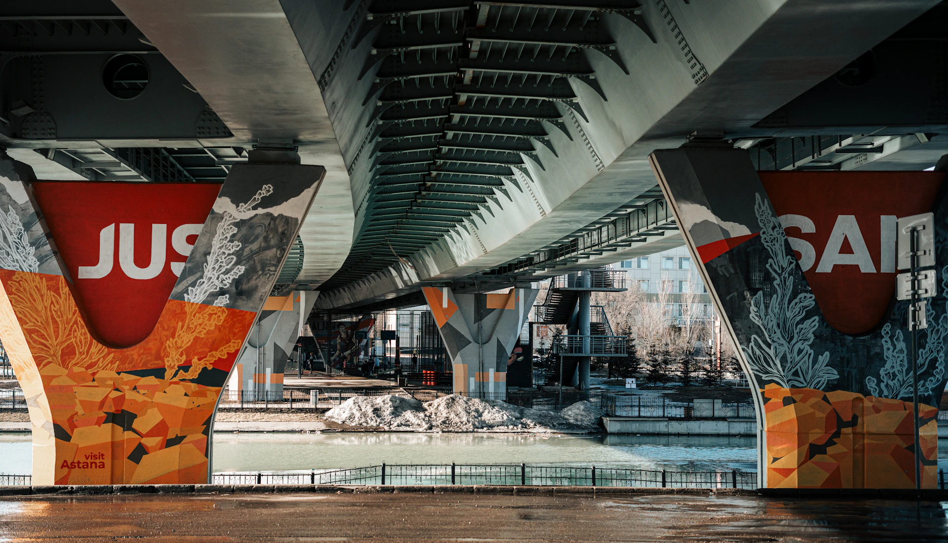 a bridge that has a mural on the side of it