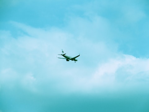 A cargo airplane soaring through a clear blue sky.