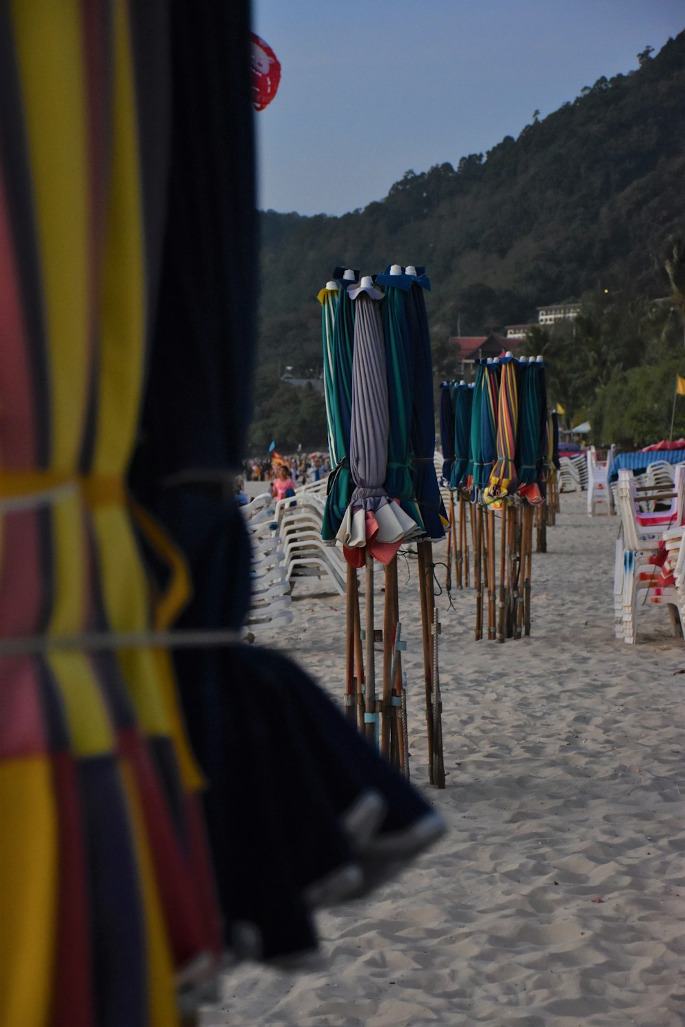 a row of beach chairs sitting on top of a sandy beach