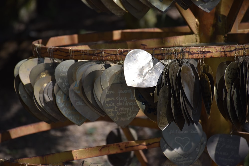 a bunch of metal discs hanging from a tree