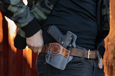 a man with an outer holster on hip