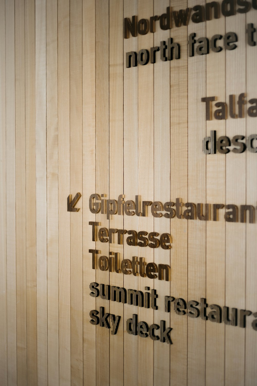 a wooden wall with words written on it