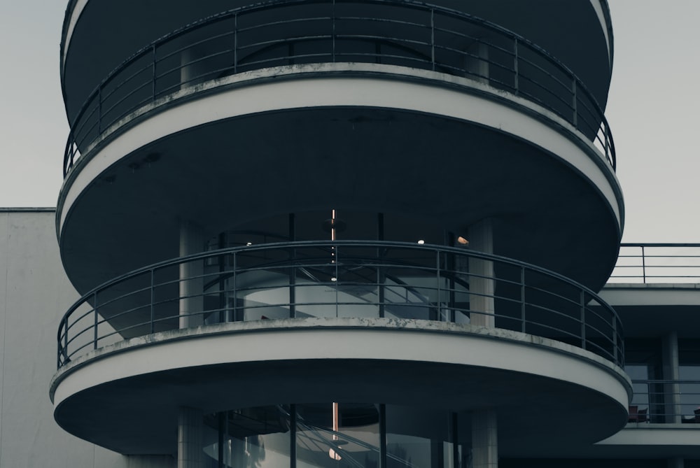 a tall building with a balcony and a clock on it