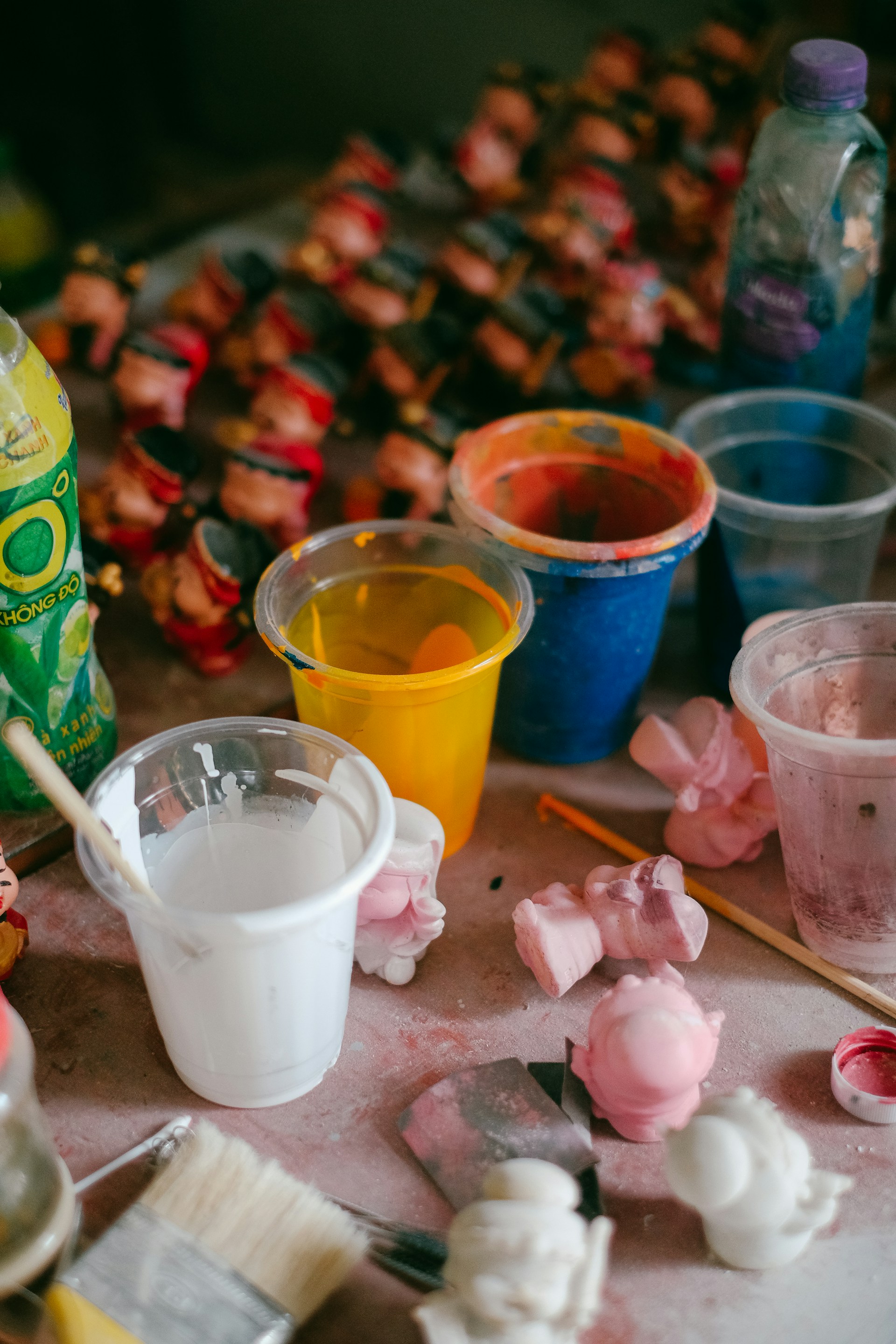 a table topped with lots of different types of paint
