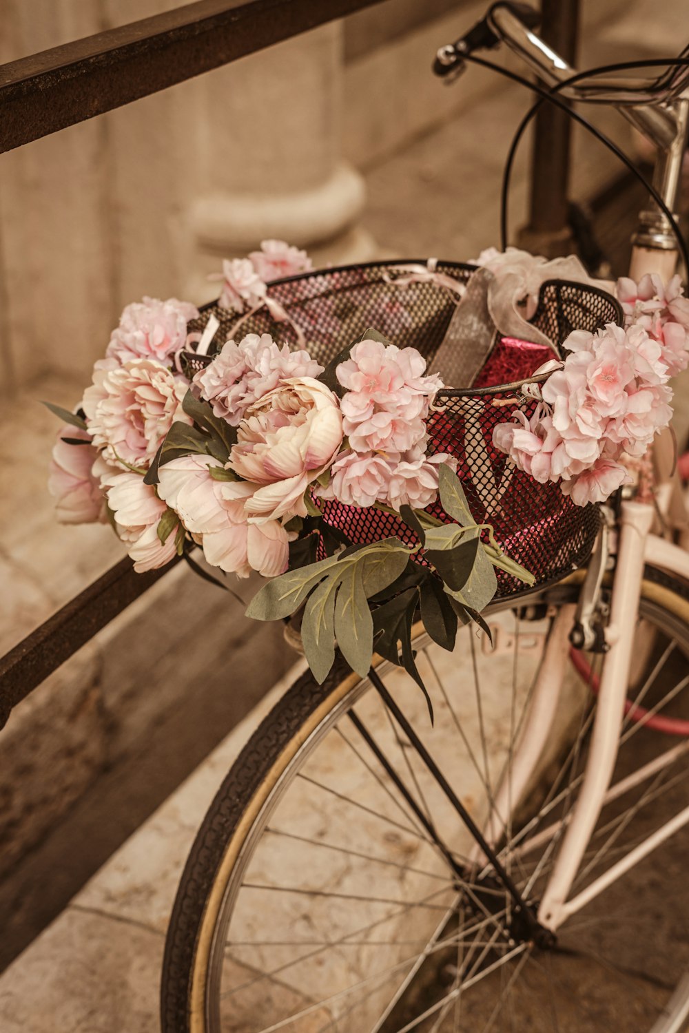 a close up of a bicycle with flowers on it