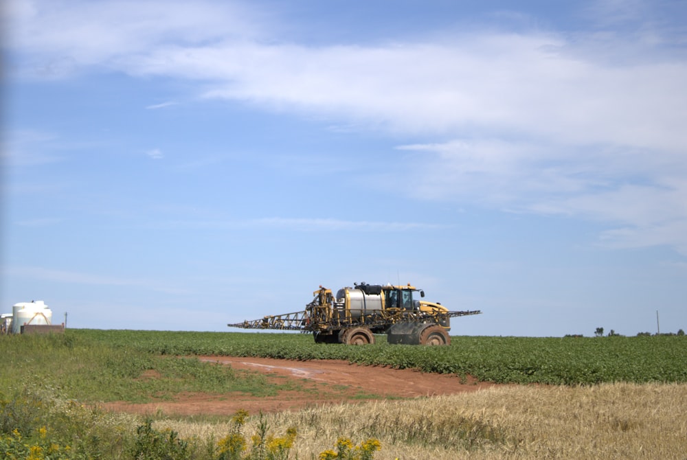 a tractor is driving through a field of crops