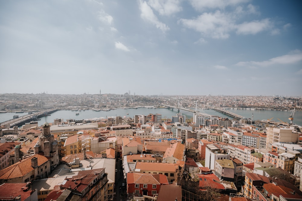 an aerial view of a city with a bridge in the background