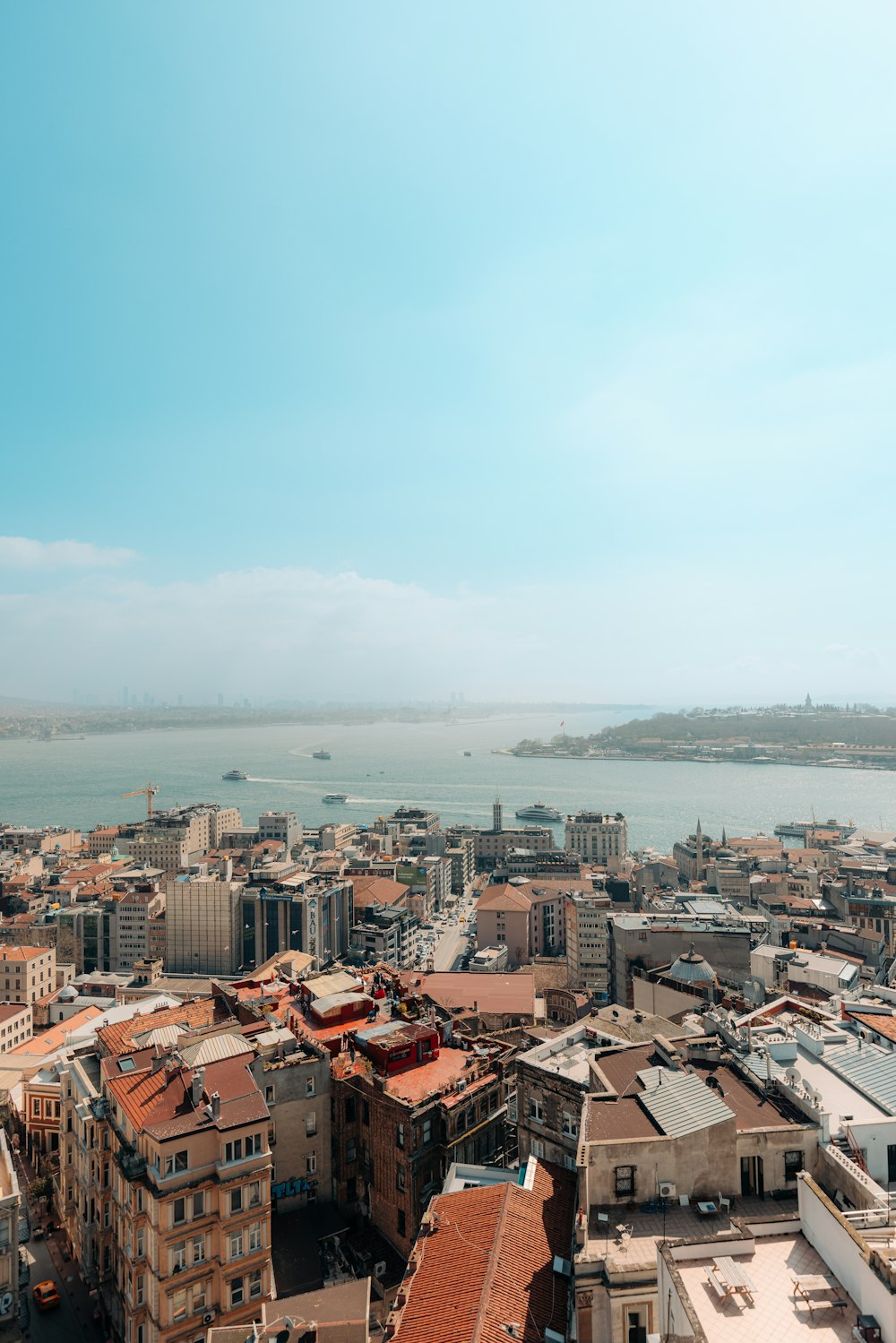 a view of a city with a body of water in the background