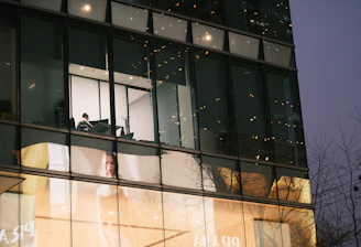 Modern real estate agent showing a client a property brochure in a bright office.