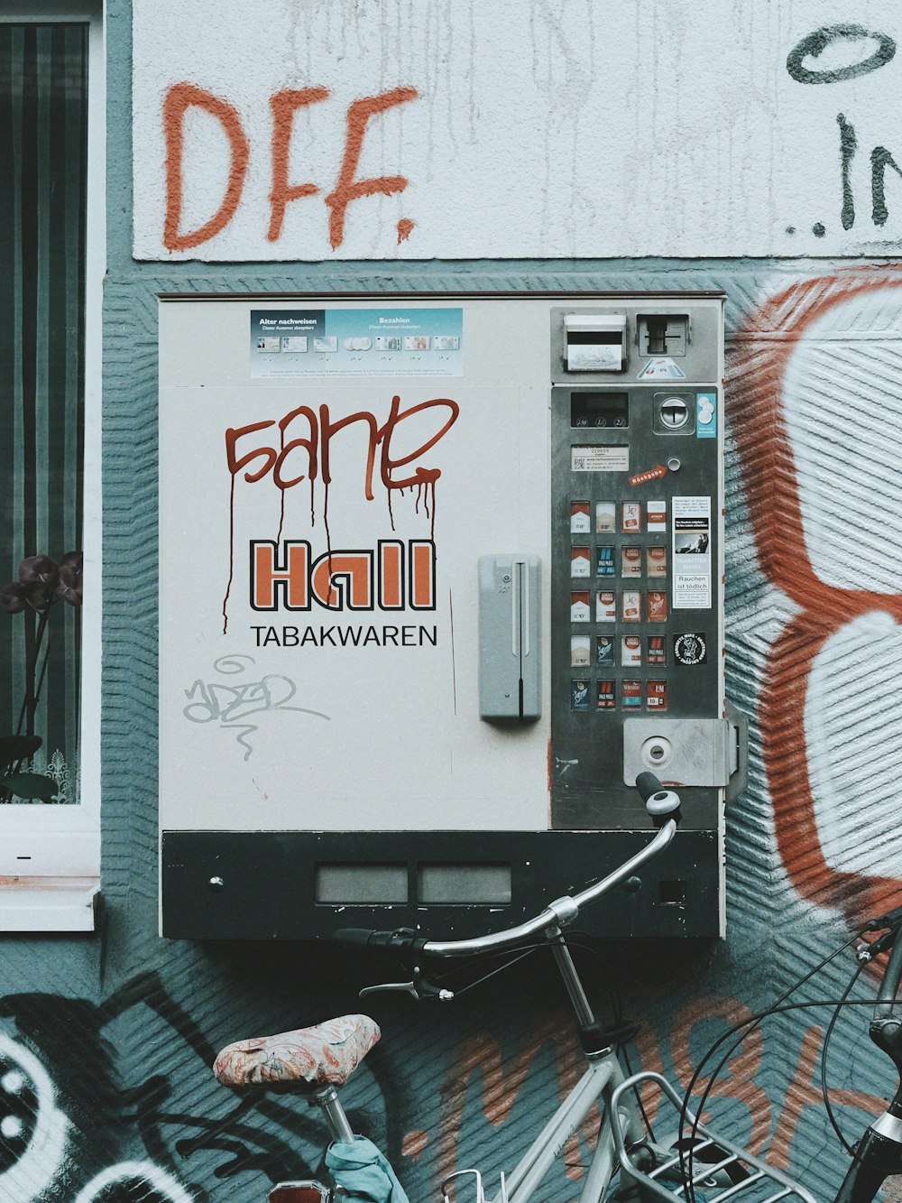 a vending machine with graffiti on the side of a building