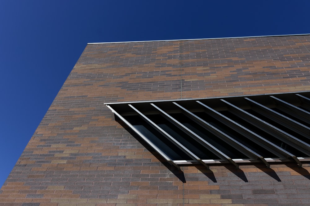 a tall brick building with a window on the side