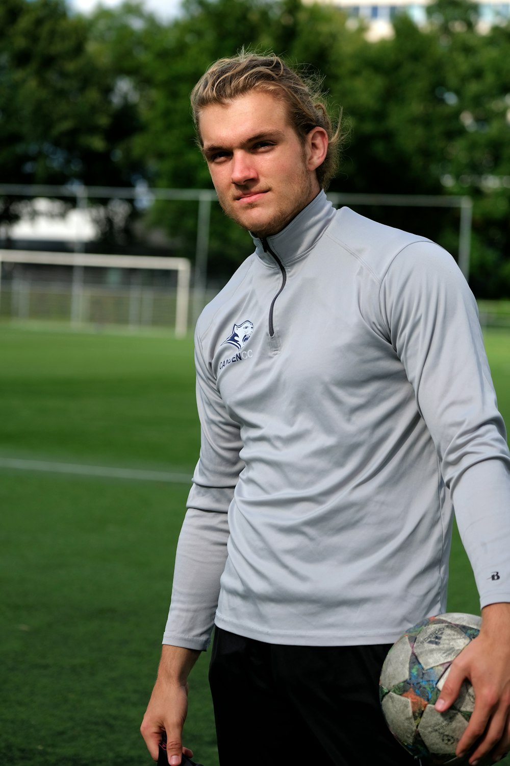 a man holding a soccer ball on a field