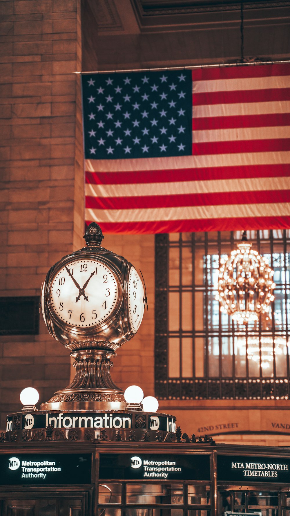 a clock in front of an american flag