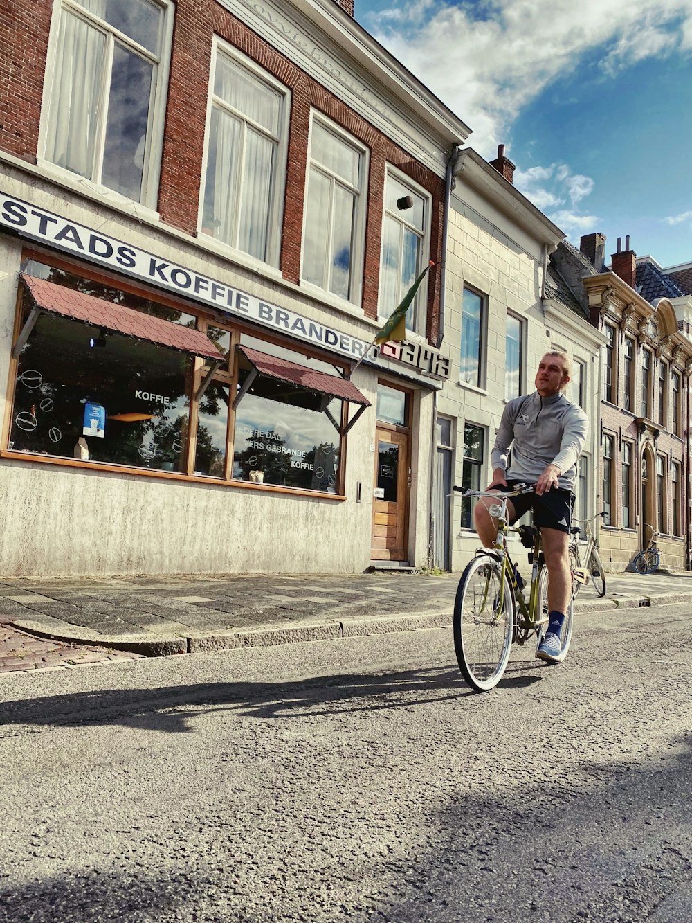 a man riding a bike down a street