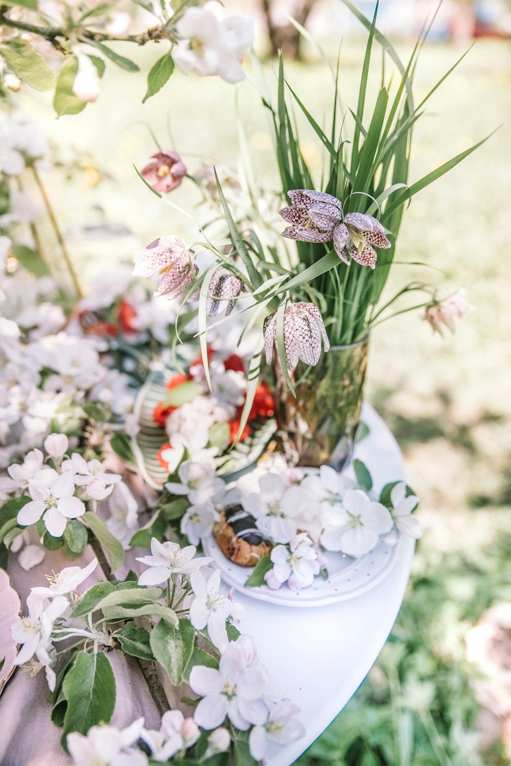 a table topped with a vase filled with flowers