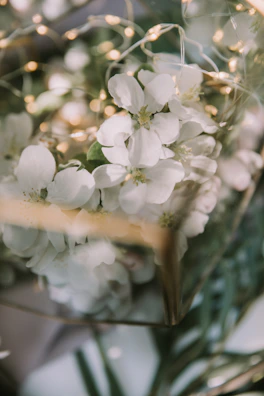 Delicate floral decor details with soft natural textures and warm lighting.