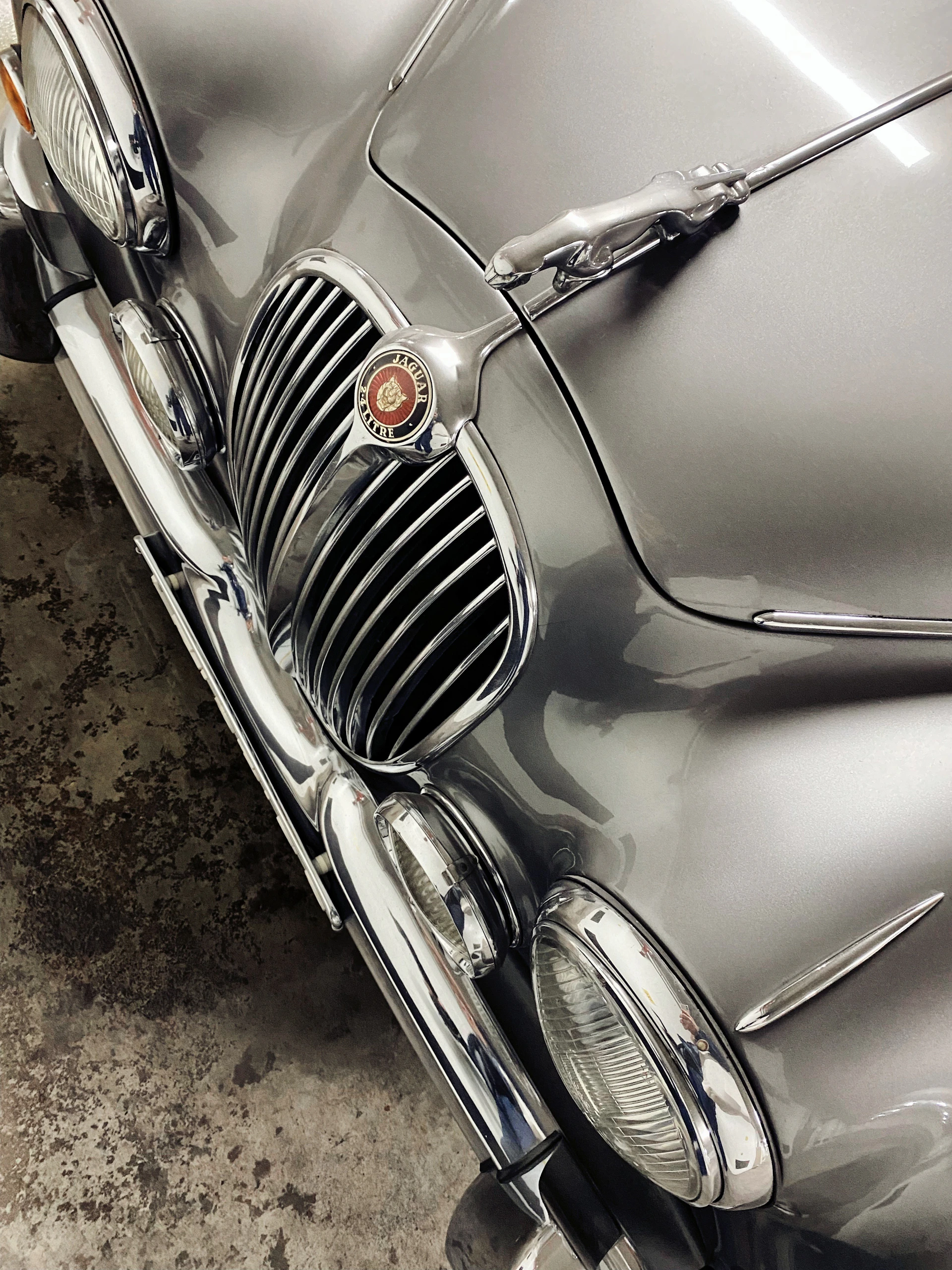 a close up of the front of a silver car