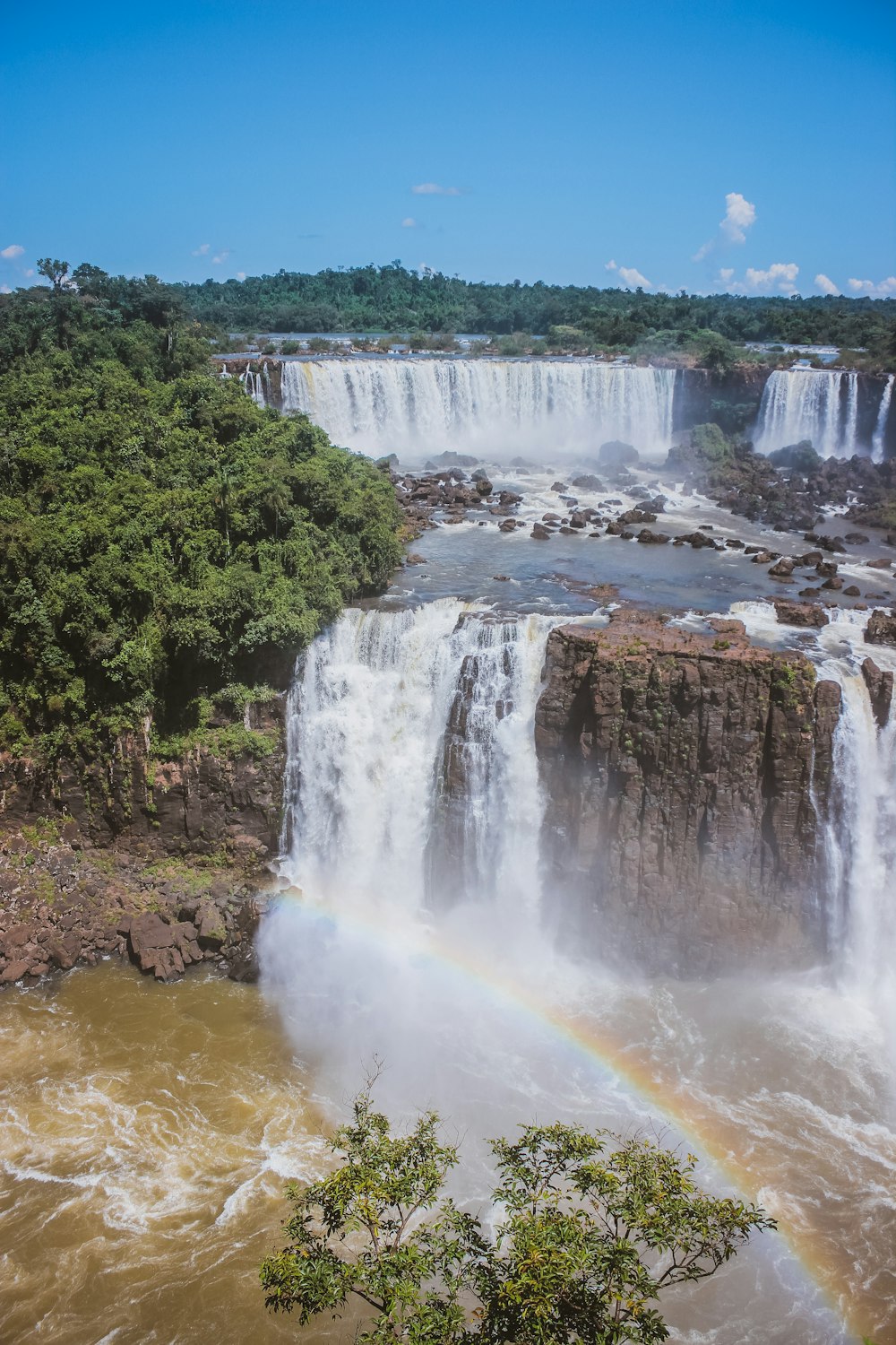 a waterfall with a rainbow in the middle of it