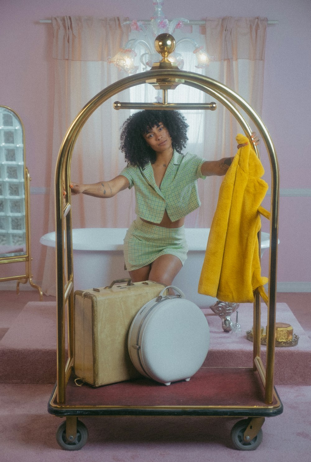 a woman sitting on a bathtub holding a yellow towel