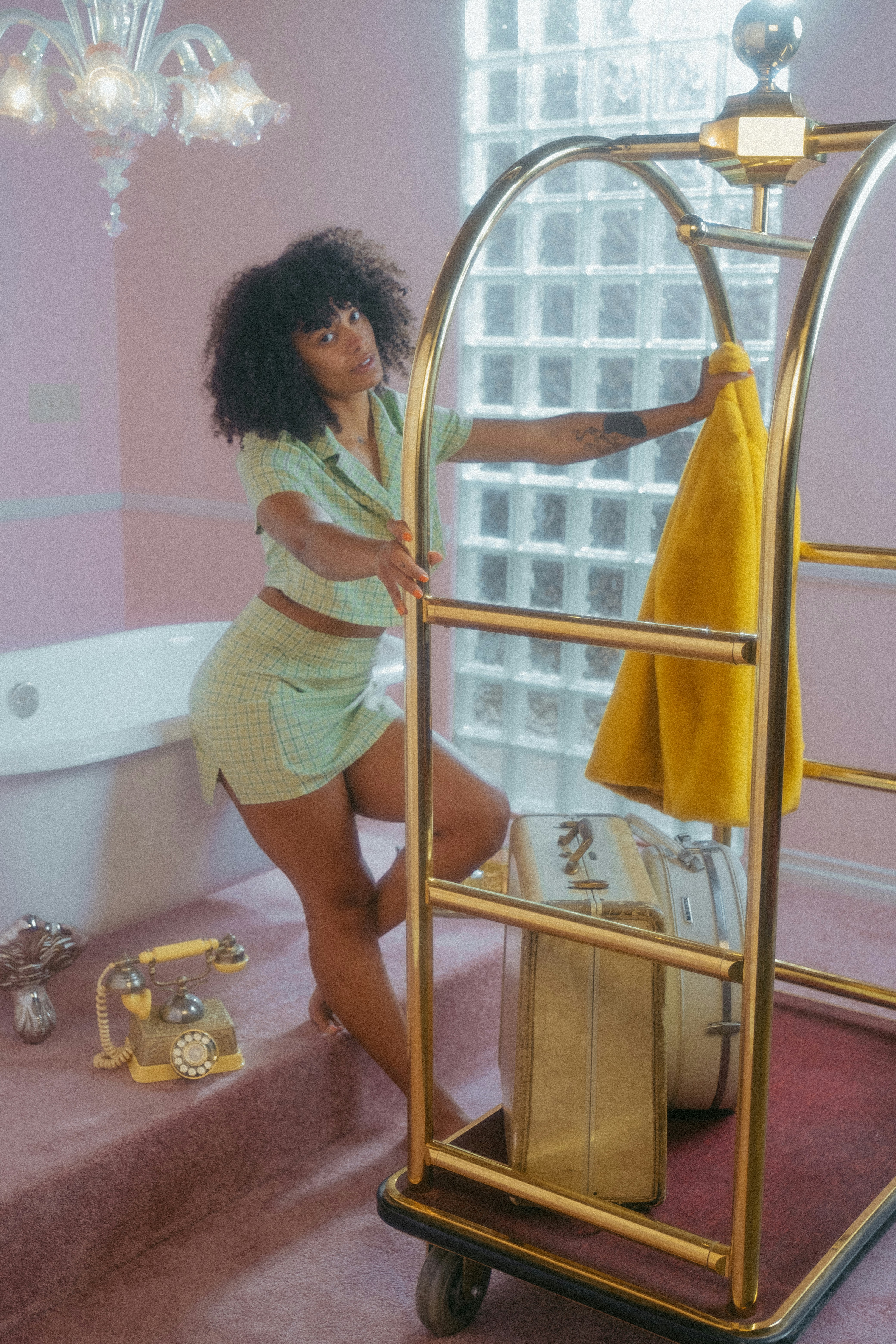 a woman standing next to a bath tub in a bathroom