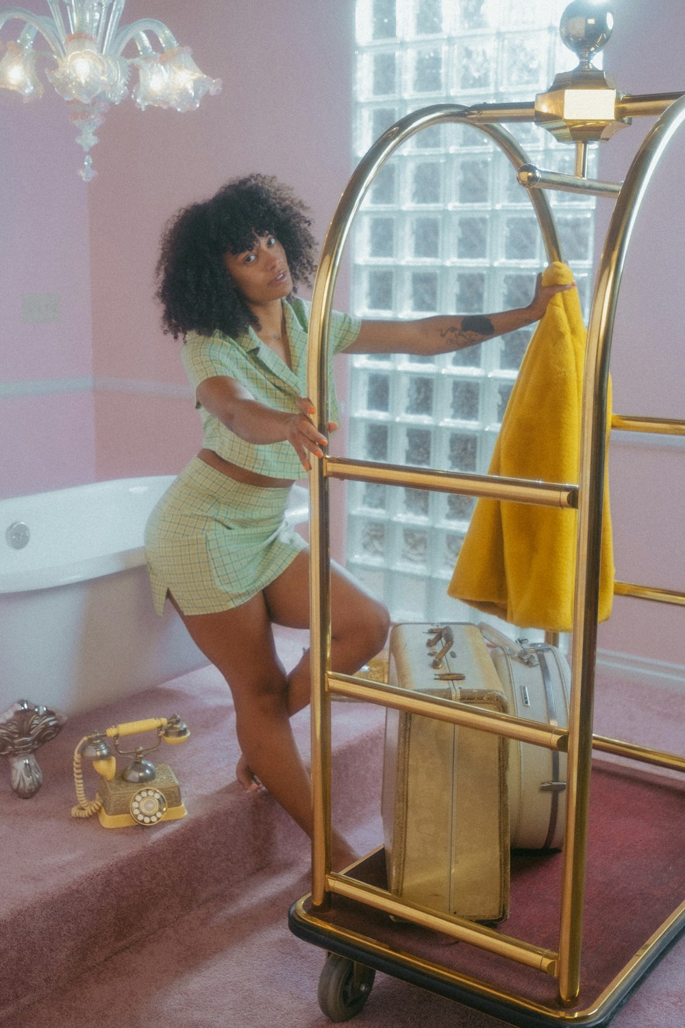 a woman standing next to a bath tub in a bathroom