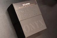 Close-up of the éclatvive logo embossed on a sleek black gift box, emphasizing brand identity.