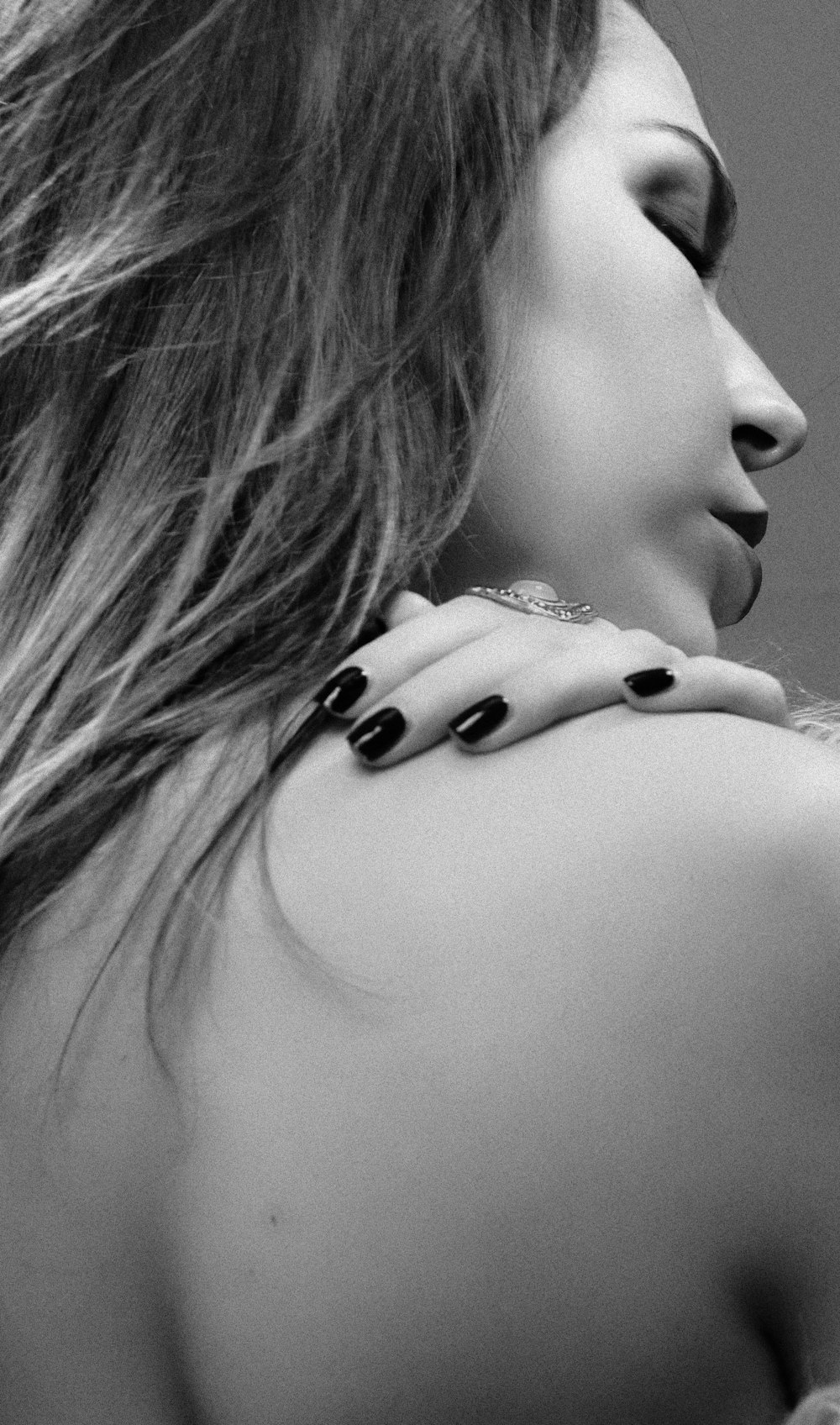 a woman with black and white nail polish on her back