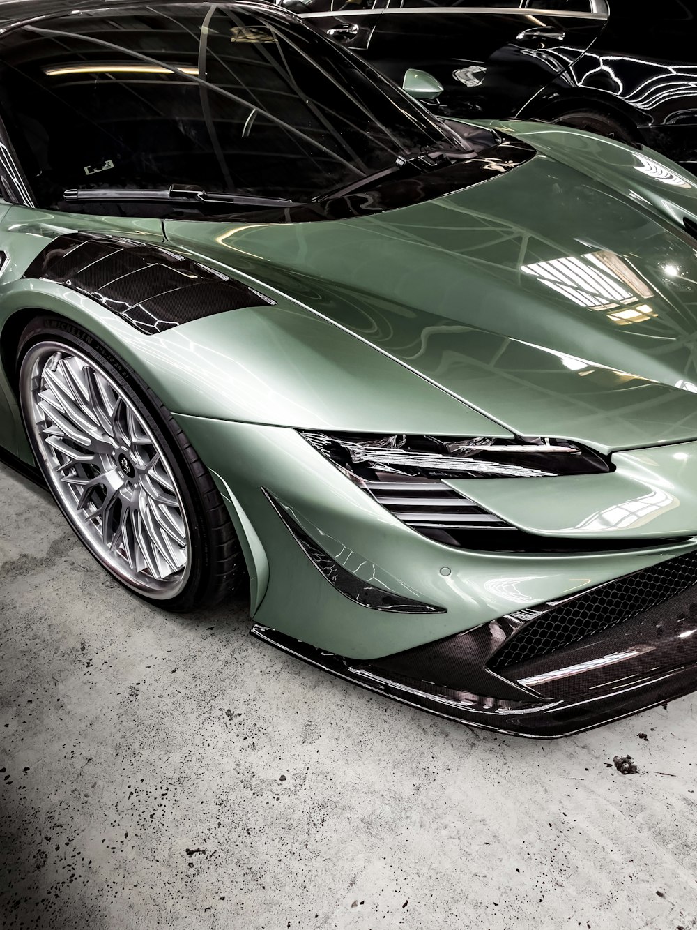 a green sports car parked in a garage