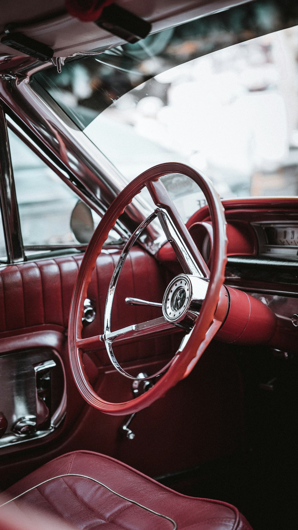 the interior of a classic car with red leather seats