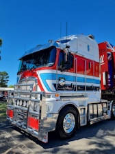 a semi truck with a red, white, and blue trailer