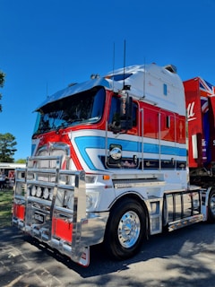 a semi truck with a red, white, and blue trailer