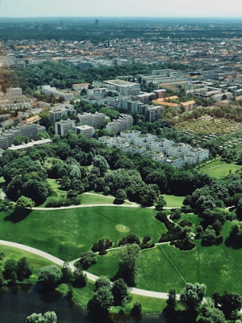 An aerial view of a mixed-use property blending residential and retail spaces surrounded by greenery.