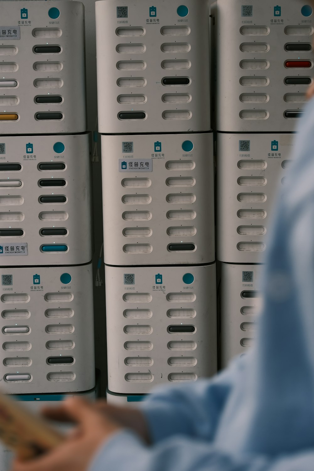 a woman standing in front of stacks of white boxes