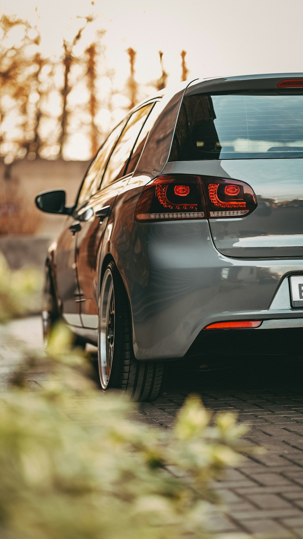 a silver car parked on a brick road