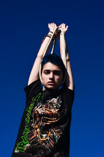 A vibrant twirléa hula hoop spinning gracefully against a clear blue sky.