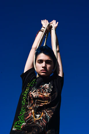 A vibrant twirléa hula hoop spinning gracefully against a clear blue sky.