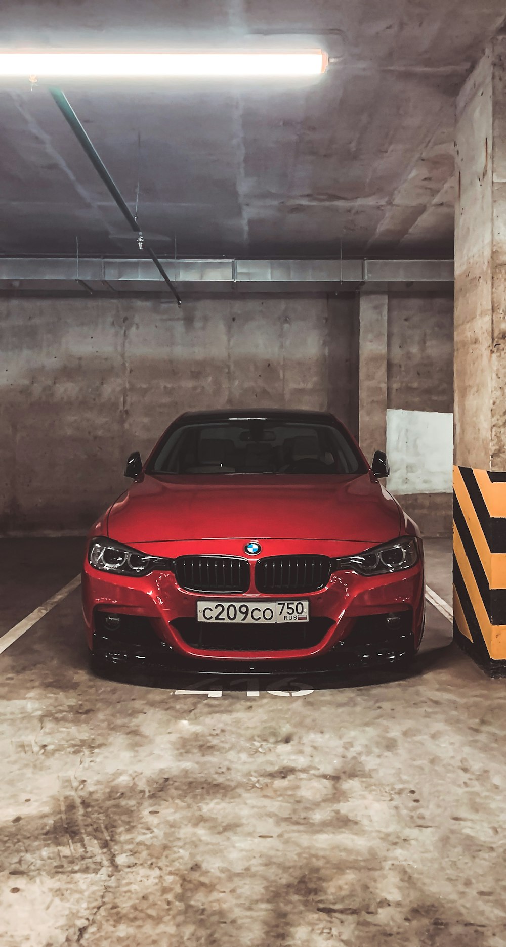 a red car parked in a parking garage