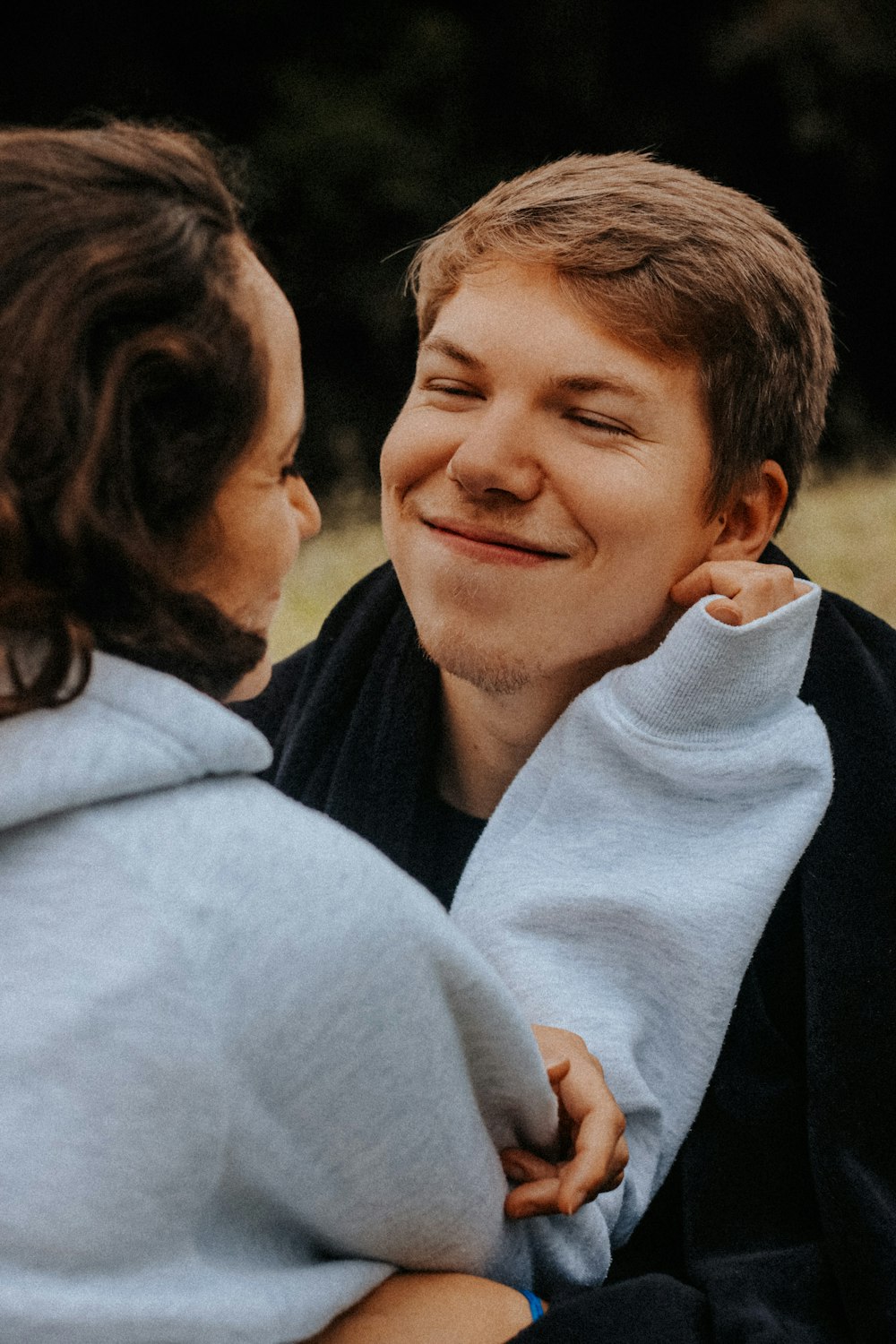 a man holding a woman's back and smiling