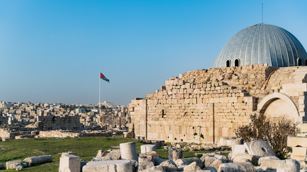 a large stone structure with a flag on top of it