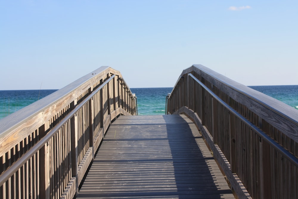 a wooden walkway leading to the ocean