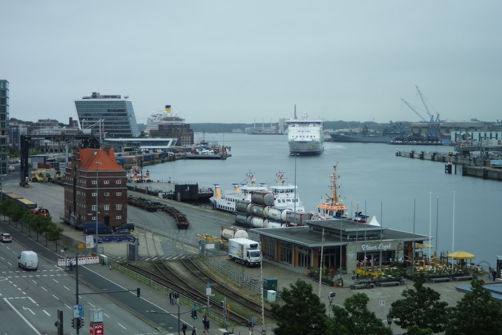 a harbor filled with lots of boats next to tall buildings